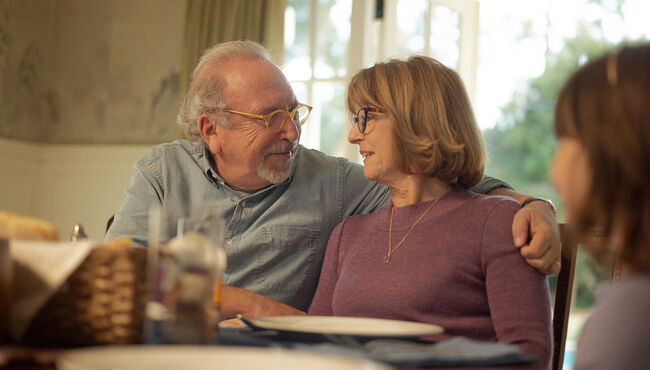 senior couple looking at each other at dining table