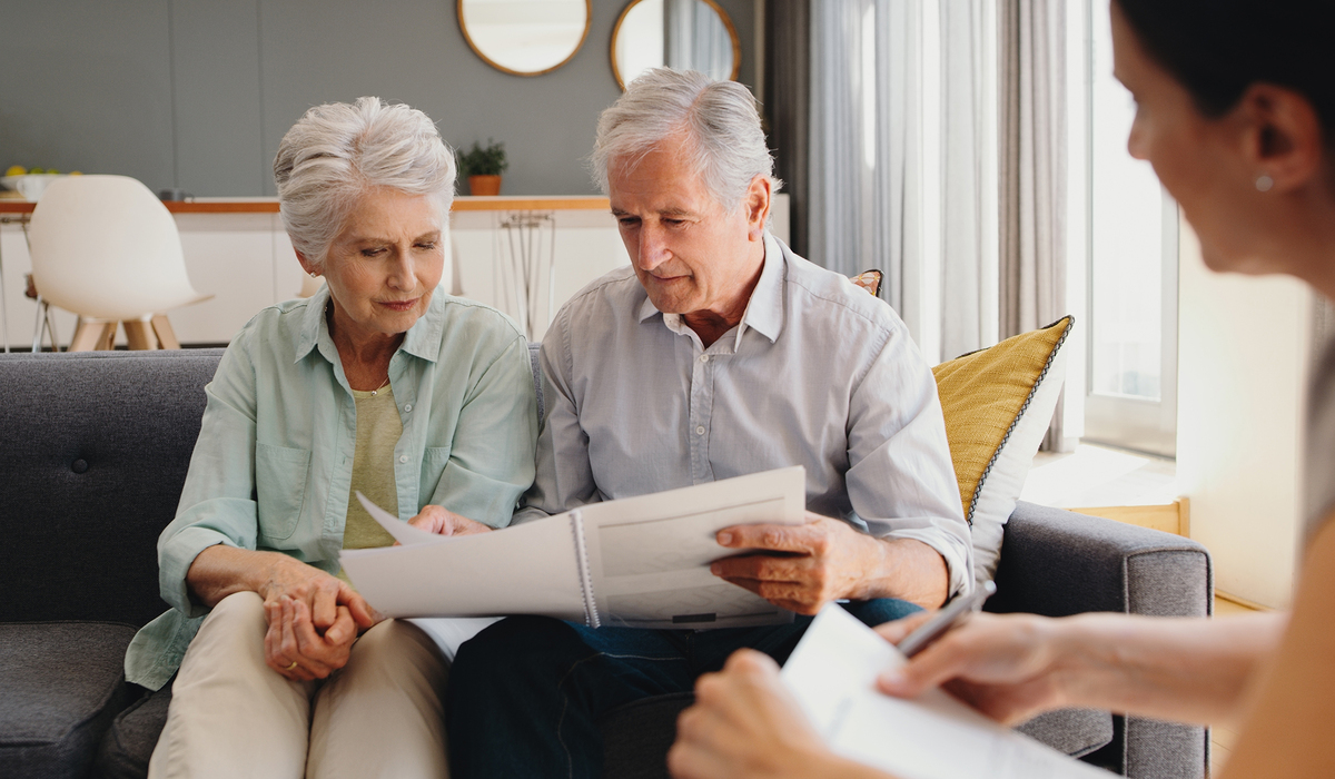 Senior couple writing will, inheritance and life insurance documents